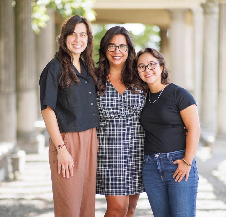 Noeida Kuhnert standing with her two daughters.
