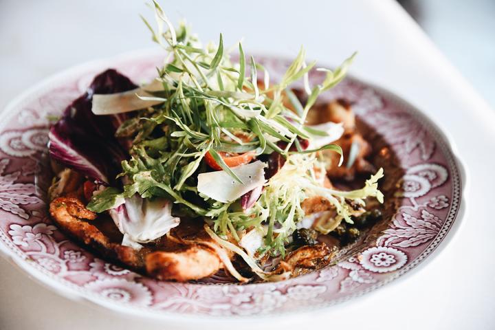 Delicate salad on a china plate.