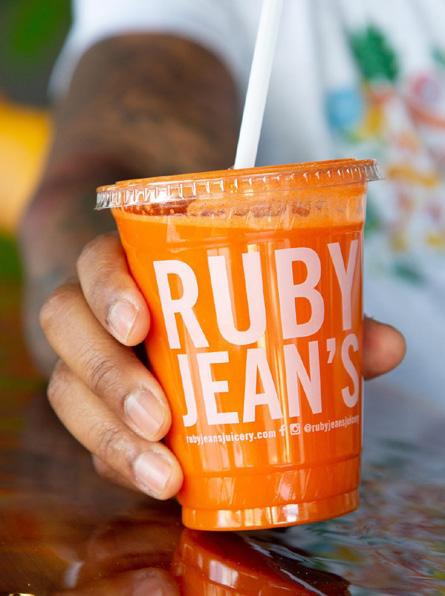 Plastic cup of orange juice from Ruby Jean's Juicery.