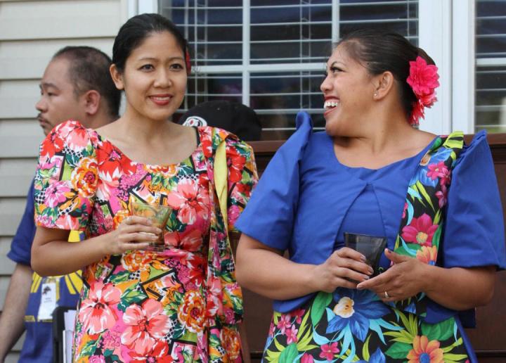 Two Filipino women in traditional dress talking