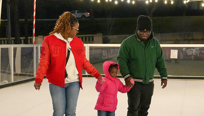 Family skating on outdoor ice rink