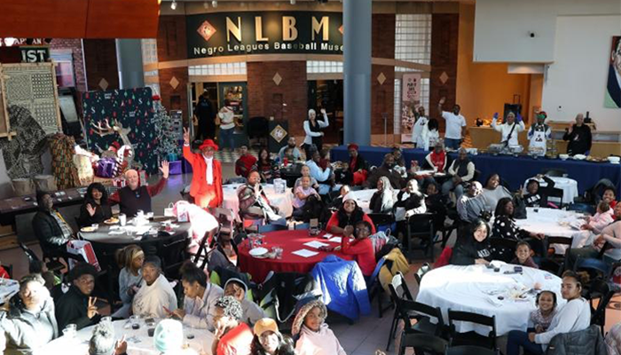 large group of people gathered around tables to eat