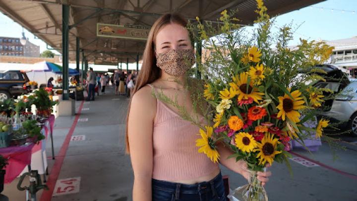 Woman with flowers from farmers market. 