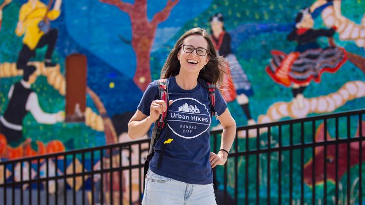 Lisa Pena in front of mural on urban hike