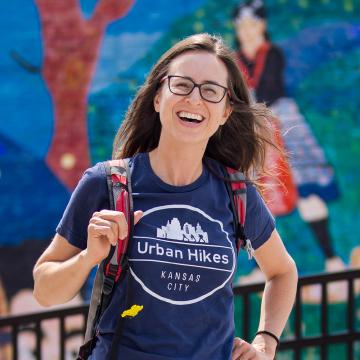 Lisa Pena in front of mural on urban hike