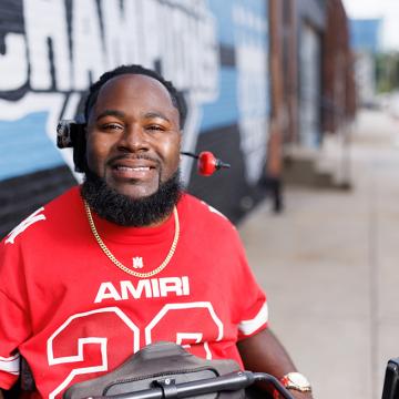 Will Smith smiling in front of the Royals World Series mural in downtown Kansas City